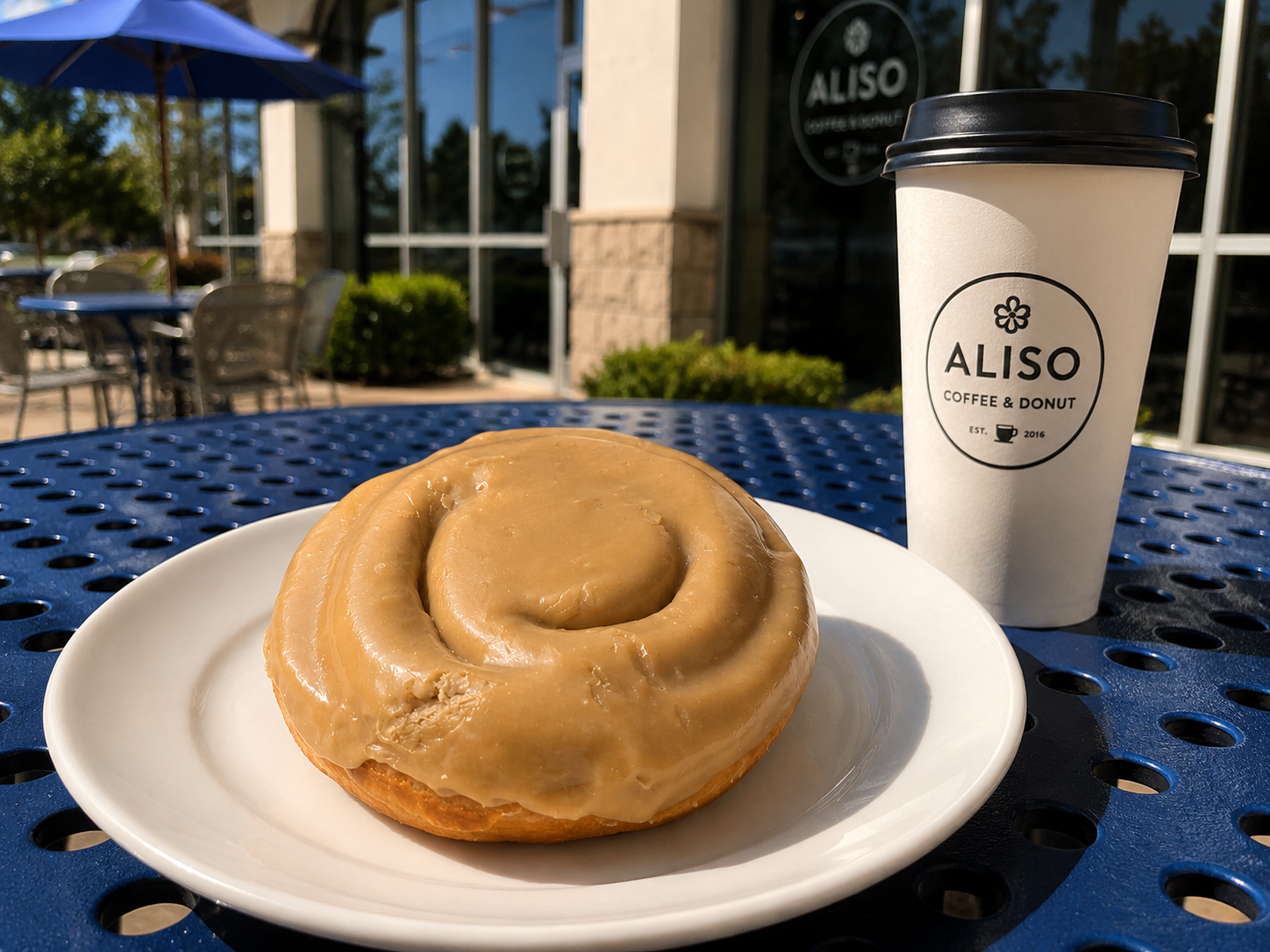 Donut and coffee outside Aliso Coffee & Donut